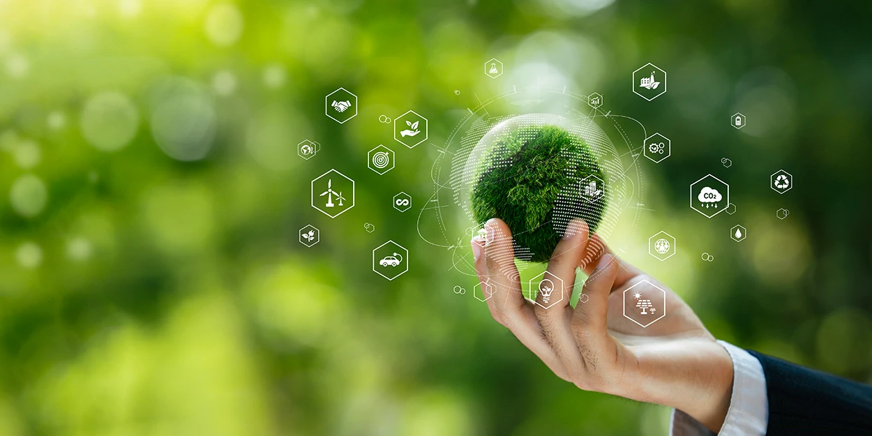 Sustainability reporting: A hand holds a small replica of the globe.